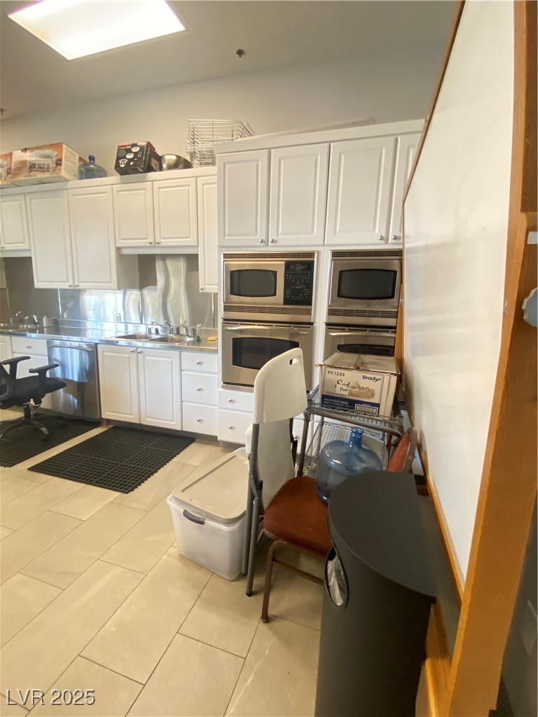 172 Tall Ruff Drive Las Vegas, NV 89148 - Photo 74 of 94 Kitchen with wall oven, dishwasher, light countertops, stainless steel oven, and white cabinets