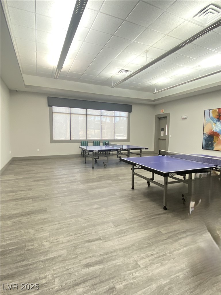 172 Tall Ruff Drive Las Vegas, NV 89148 - Photo 75 of 94 Playroom featuring a tray ceiling, wood finished floors, visible vents, and baseboards