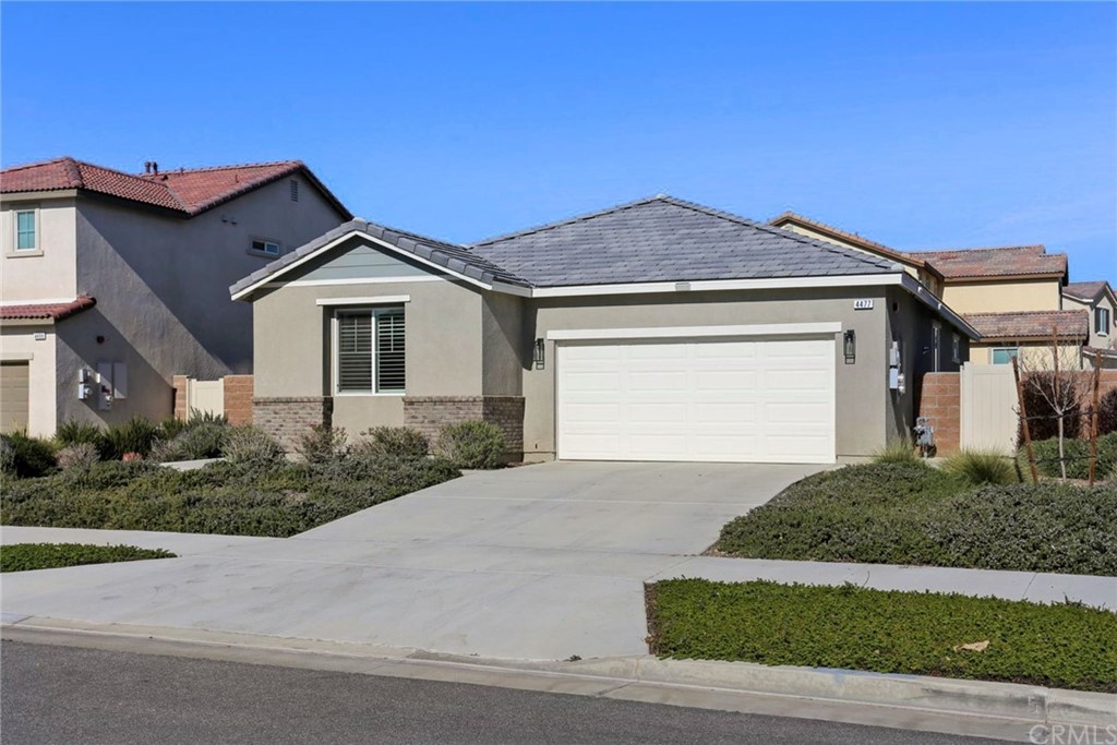 4477 Banana Grove Riverside, CA 92501 - Photo 1 of 1 a front view of a house with a yard and garage