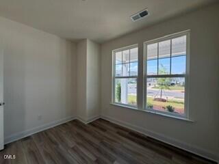 706 Old Station Angier, NC 27501 - Photo 9 of 19 a view of an empty room with wooden floor and a window