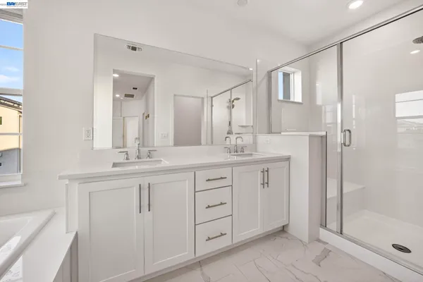 a bathroom with a granite countertop sink mirror and shower