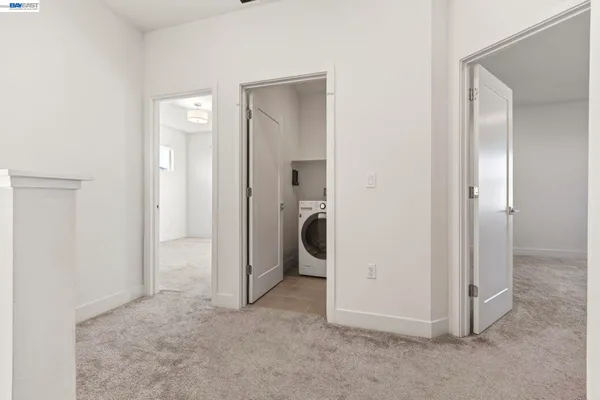 an empty room with closet and a bathroom view