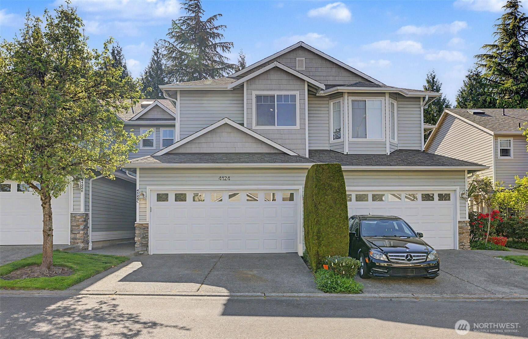 4124 214th Street Southwest, Unit C Mountlake Terrace, WA 98043 - Photo 1 of 20 a front view of a house with a garden