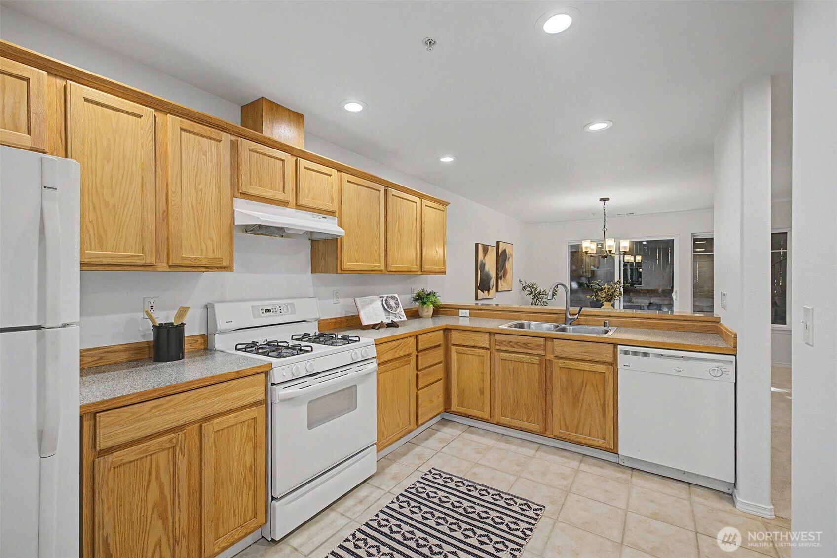 4124 214th Street Southwest, Unit C Mountlake Terrace, WA 98043 - Photo 5 of 20 a kitchen with a stove top oven sink and cabinets