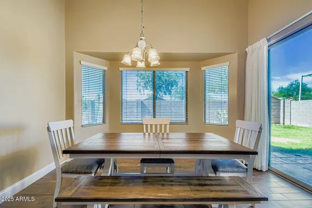 a kitchen with stainless steel appliances granite countertop a stove top oven a sink dishwasher and white cabinets with wooden floor