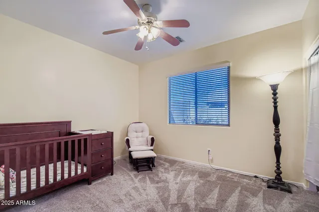 a bedroom with a bed and a chair