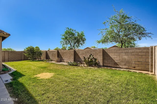 a backyard of a house with table and chairs