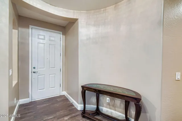 a living room with furniture a table and a large window