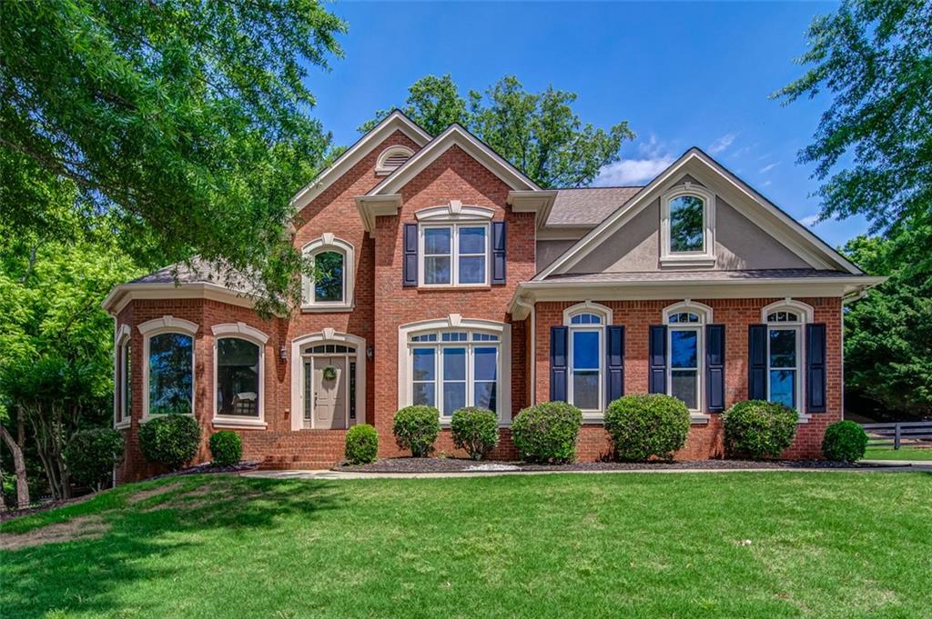 a front view of a house with a yard