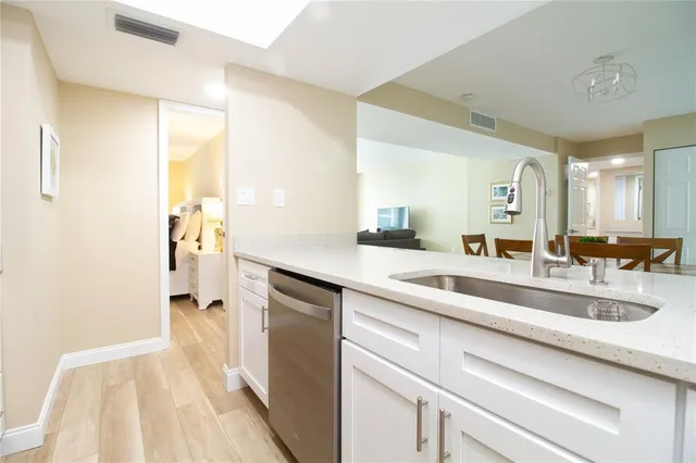 a view of a bathroom with a sink and mirror