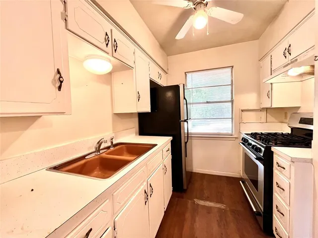 a kitchen with a sink stove and refrigerator