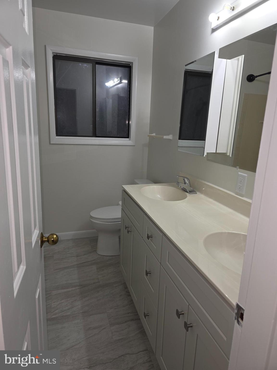 206 Skyhill Road, Unit 8 Alexandria, VA 22314 - Photo 13 of 16 a bathroom with a sink and mirror with toilet
