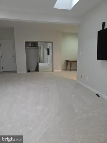 a view of an empty room with a kitchen