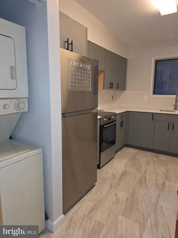 a kitchen with stainless steel appliances a refrigerator sink and cabinets