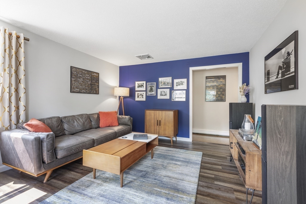 61 Sunset Drive Milford, MA 01757 - Photo 14 of 42 a living room with furniture and a wooden floor