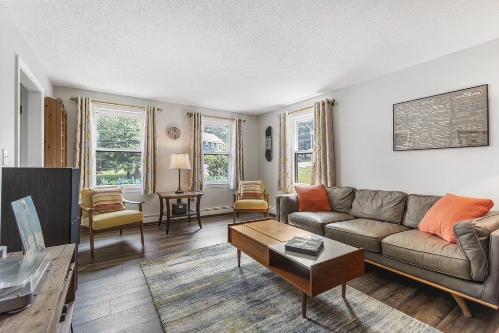 61 Sunset Drive Milford, MA 01757 - Photo 15 of 42 a living room with furniture and a large window