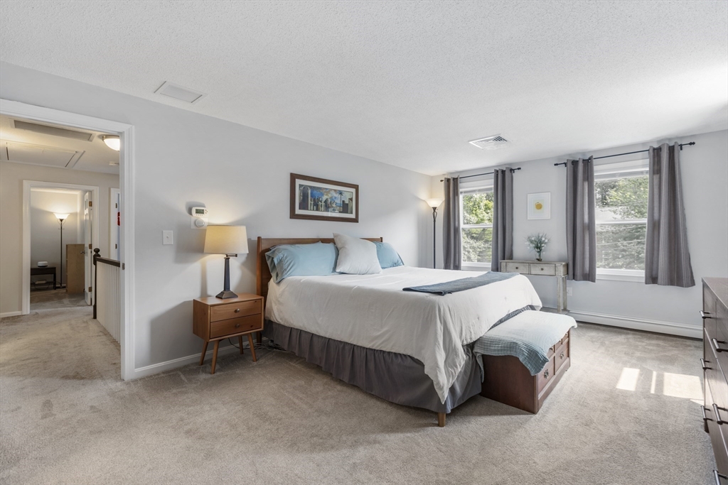 61 Sunset Drive Milford, MA 01757 - Photo 17 of 42 a spacious bedroom with a bed and large windows