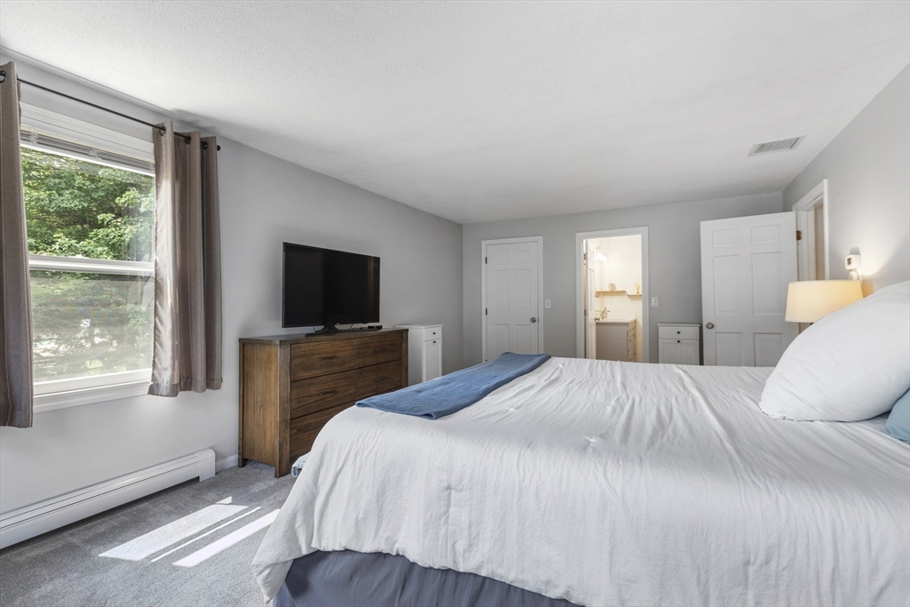 61 Sunset Drive Milford, MA 01757 - Photo 18 of 42 a bedroom with a bed and a flat screen tv