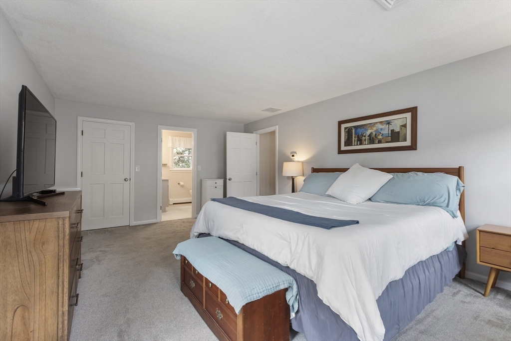 61 Sunset Drive Milford, MA 01757 - Photo 19 of 42 a bedroom with a bed and a flat screen television