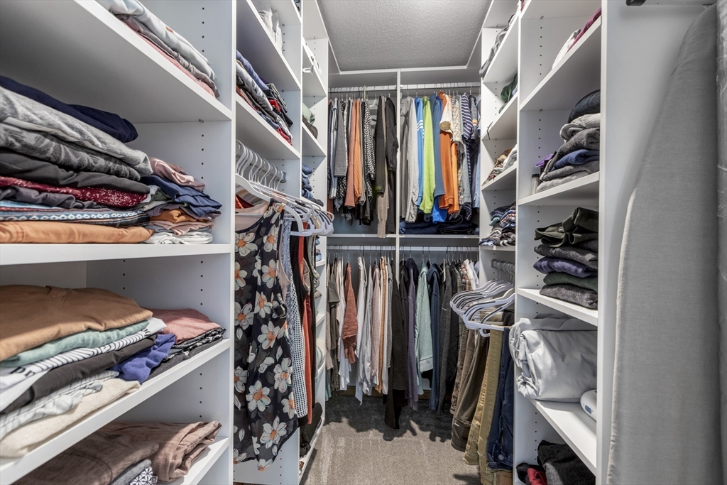 61 Sunset Drive Milford, MA 01757 - Photo 21 of 42 a view of walk in closet with clothes and shoes