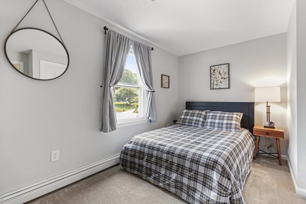 61 Sunset Drive Milford, MA 01757 - Photo 23 of 42 a bedroom with a bed and a window