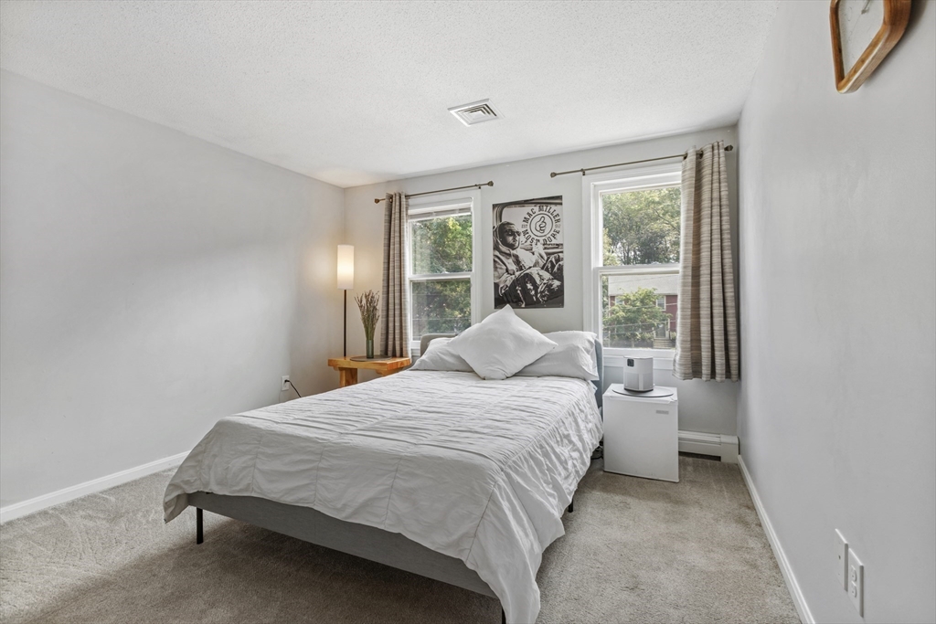 61 Sunset Drive Milford, MA 01757 - Photo 25 of 42 a bedroom with a bed and a large window