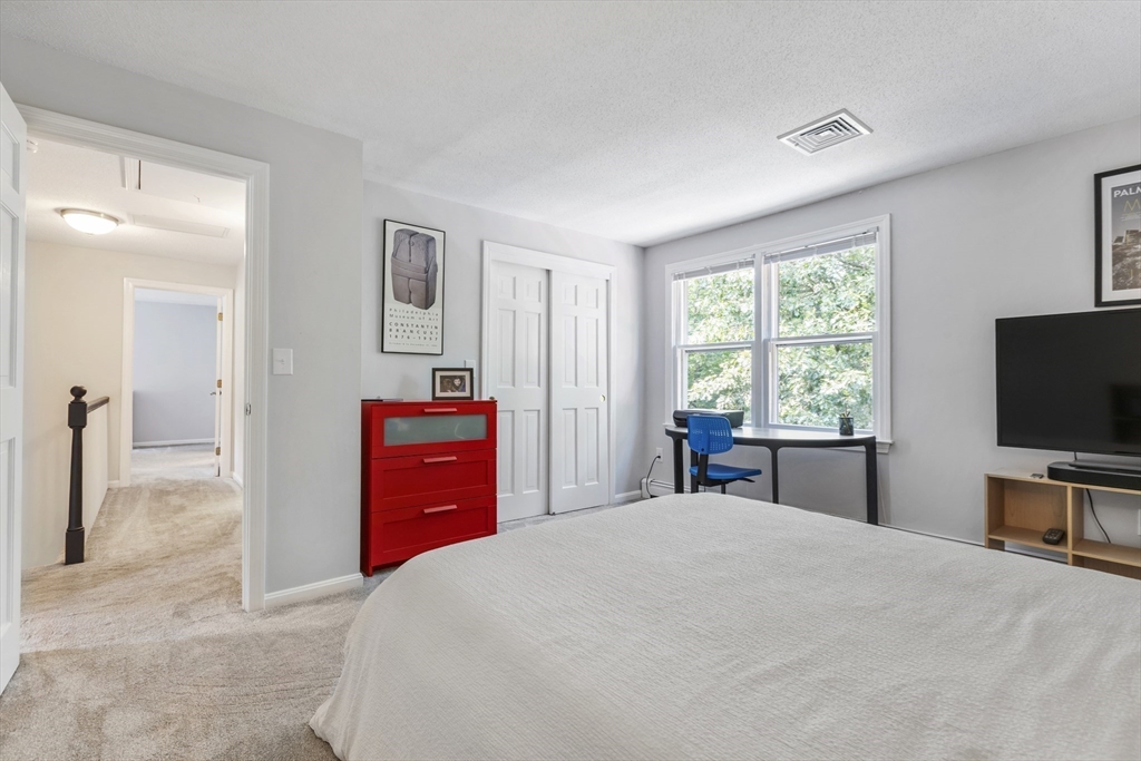 61 Sunset Drive Milford, MA 01757 - Photo 28 of 42 a bedroom with a bed and a flat screen tv