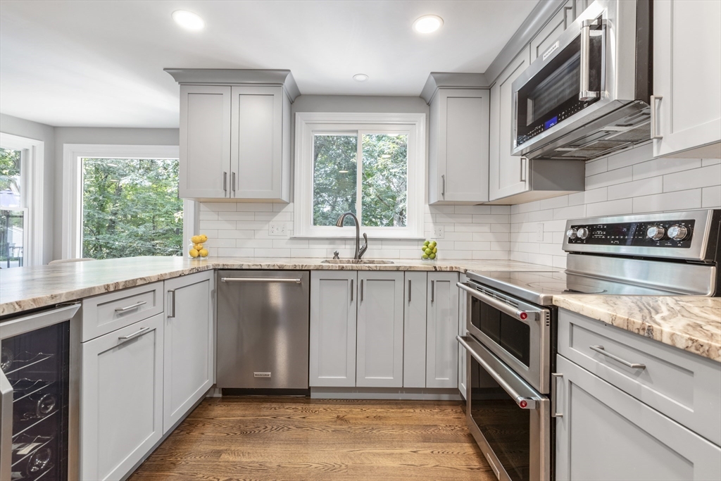 61 Sunset Drive Milford, MA 01757 - Photo 3 of 42 a kitchen with granite countertop a sink stainless steel appliances and cabinets