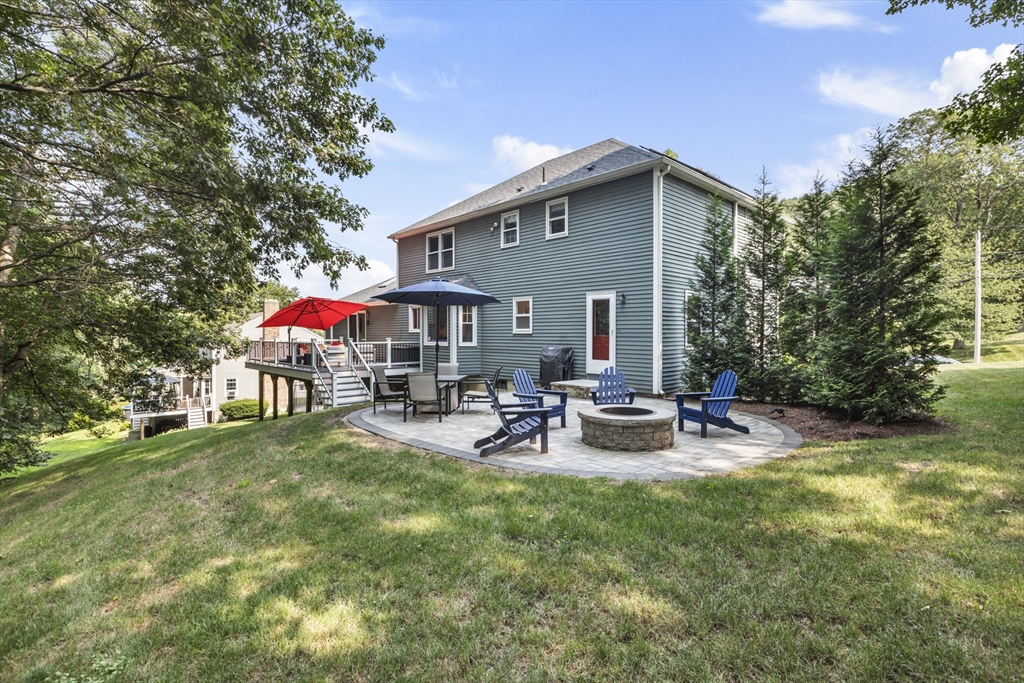61 Sunset Drive Milford, MA 01757 - Photo 41 of 42 a view of a house with backyard and sitting area