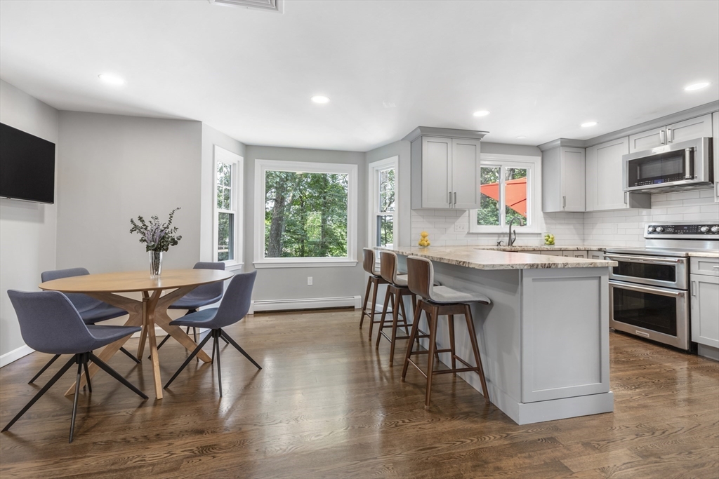 61 Sunset Drive Milford, MA 01757 - Photo 5 of 42 a view of a dining room with furniture window and wooden floor