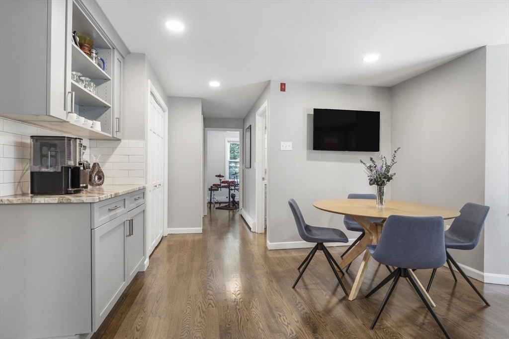 61 Sunset Drive Milford, MA 01757 - Photo 7 of 42 a kitchen with stainless steel appliances a table and chairs in it