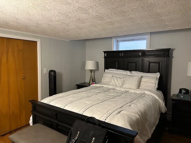 a bedroom with a bed and a night stand