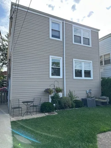 a brick house with a backyard space and a garden