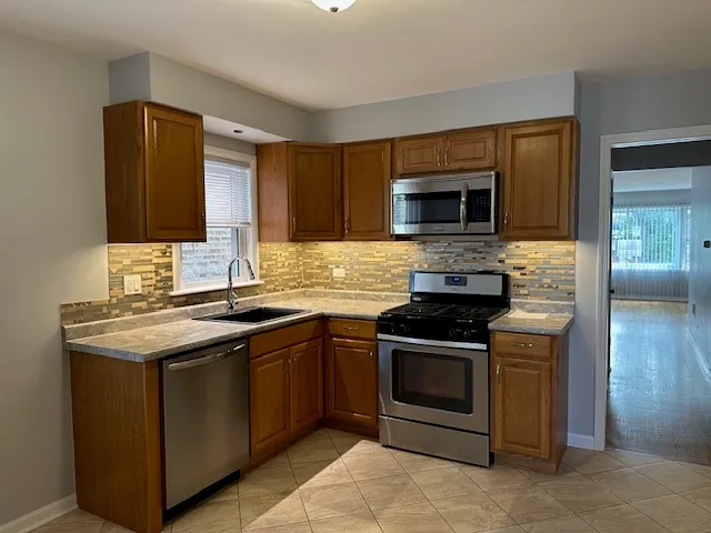 a kitchen with a stove and a microwave