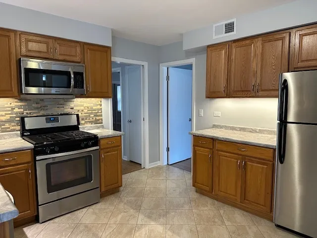 a kitchen with a stove microwave and refrigerator