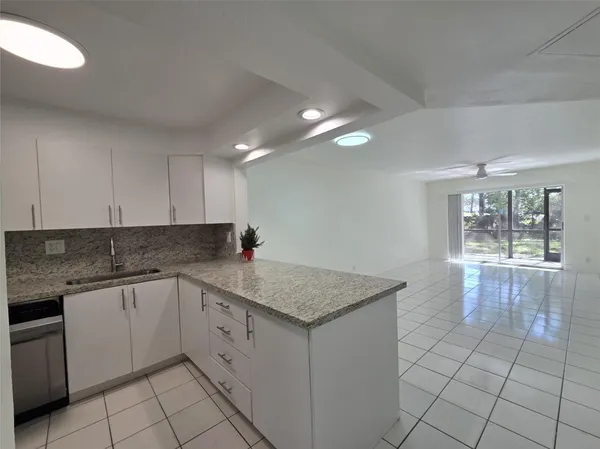 a kitchen with a sink dishwasher and cabinets