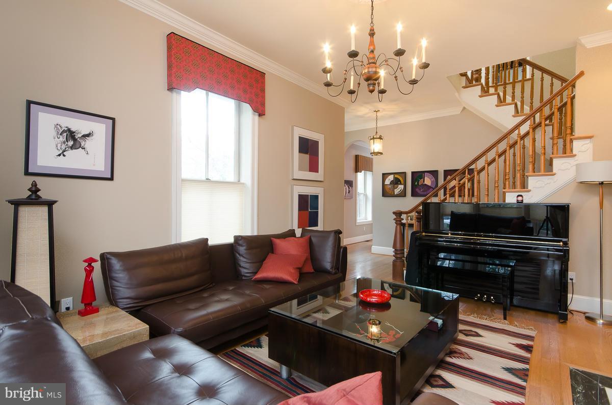 214 11th Street Northeast Washington, DC 20002 - Photo 2 of 30 a living room with furniture and a chandelier