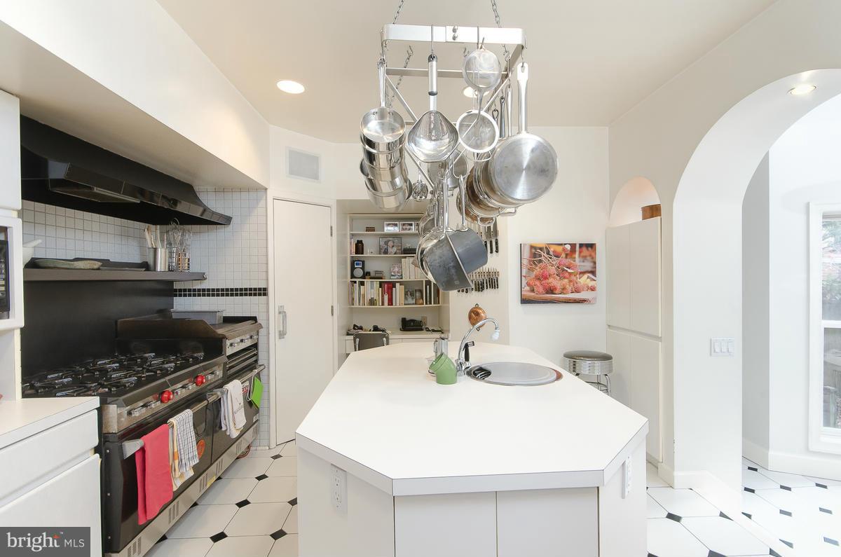 214 11th Street Northeast Washington, DC 20002 - Photo 11 of 30 a kitchen that has a lot of cabinets a sink and a stove
