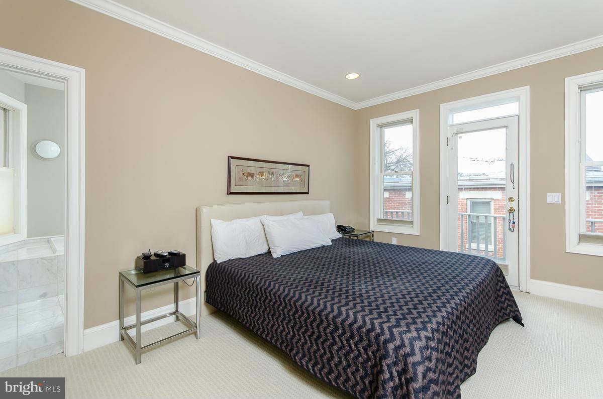 214 11th Street Northeast Washington, DC 20002 - Photo 16 of 30 a bedroom with a bed and a window