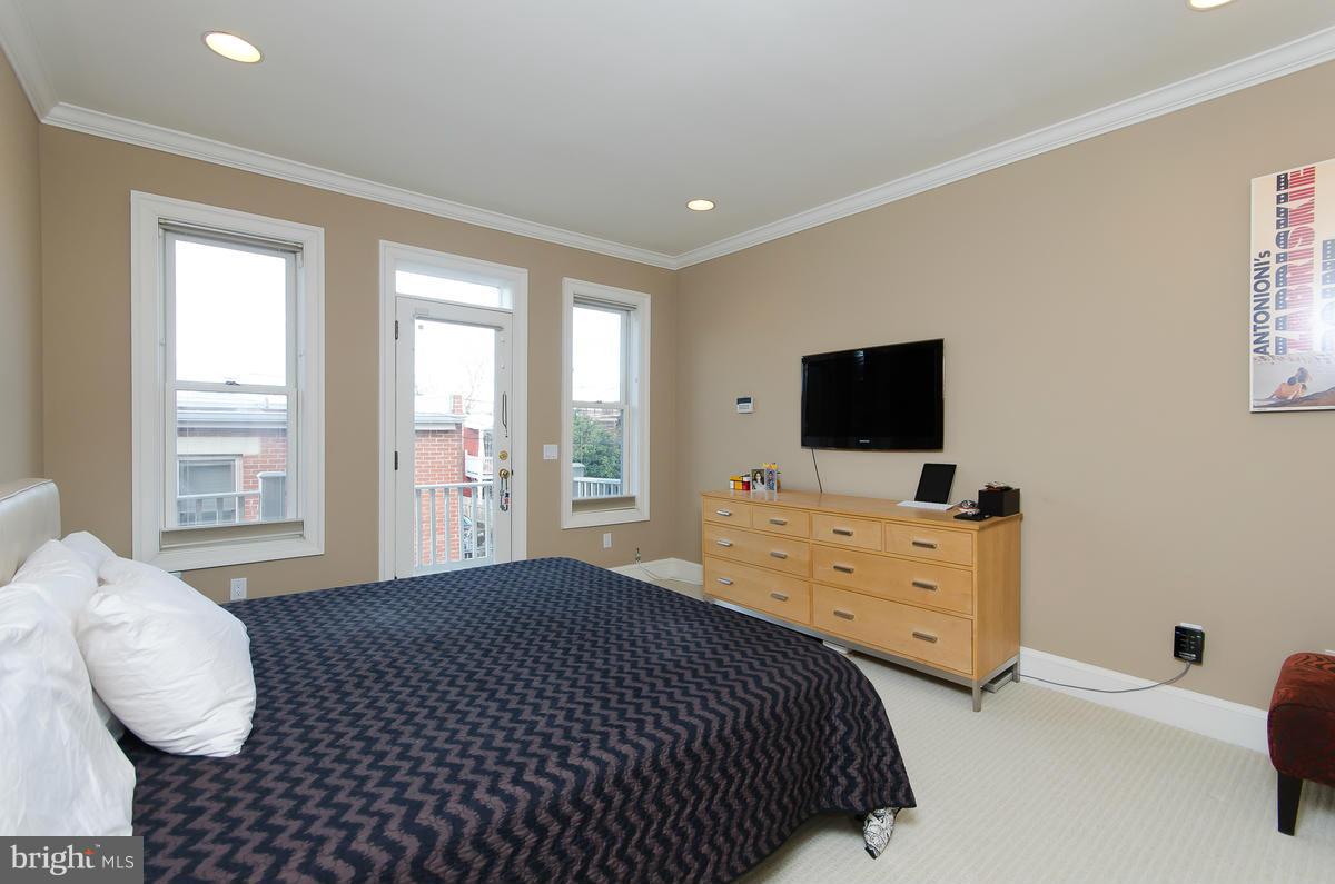 214 11th Street Northeast Washington, DC 20002 - Photo 17 of 30 a bedroom with a bed and flat screen tv