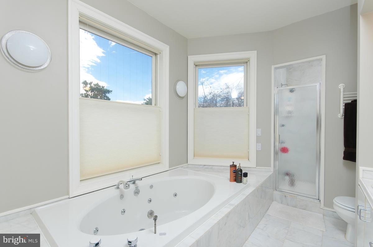 214 11th Street Northeast Washington, DC 20002 - Photo 18 of 30 a bathroom with a bathtub a window and a shower