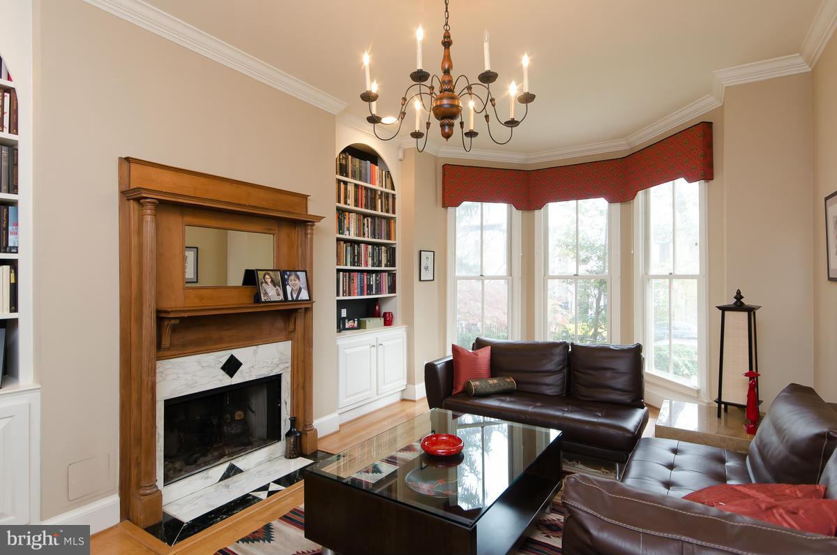 214 11th Street Northeast Washington, DC 20002 - Photo 3 of 30 a living room with furniture a fireplace and a chandelier