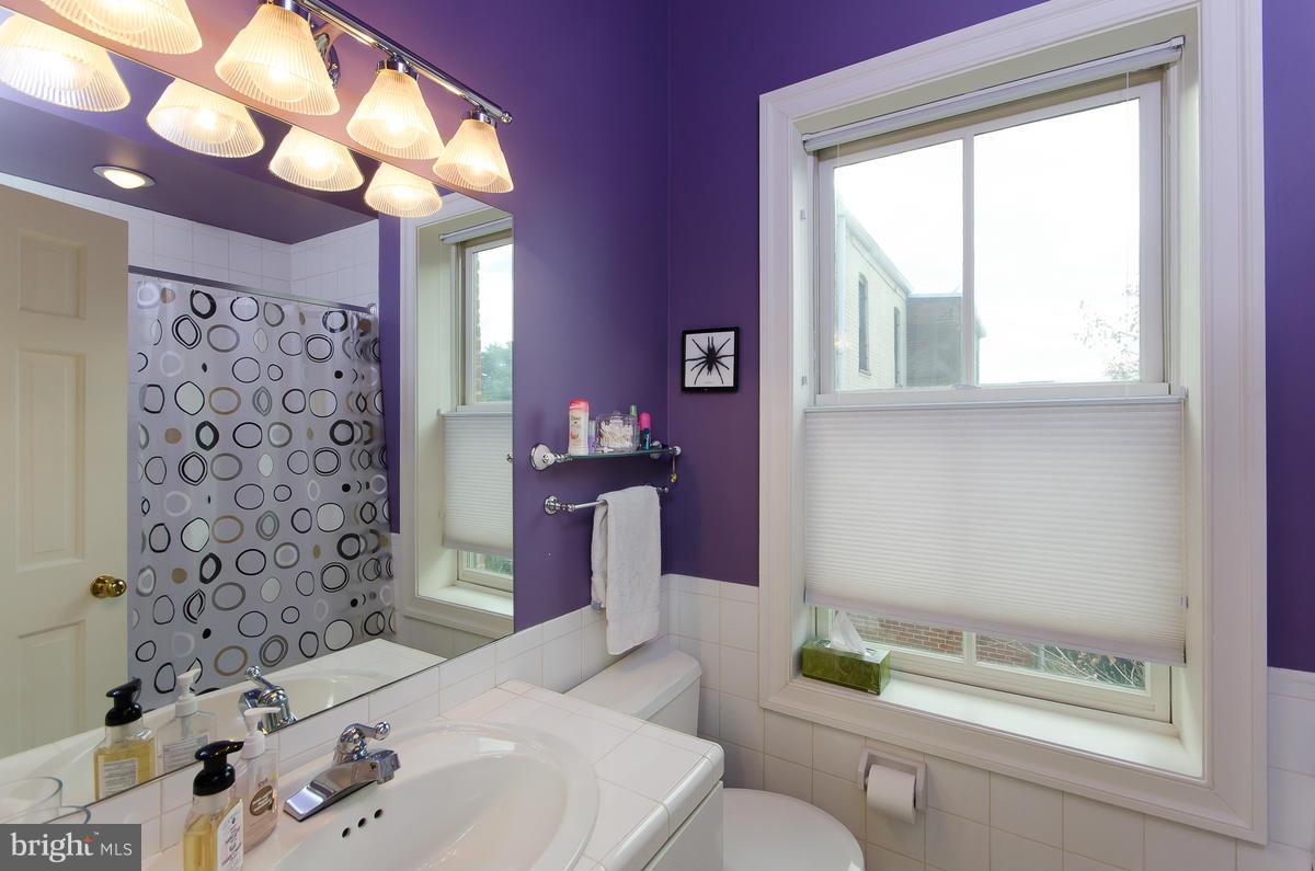 214 11th Street Northeast Washington, DC 20002 - Photo 23 of 30 a bathroom with a bathtub sink and mirror