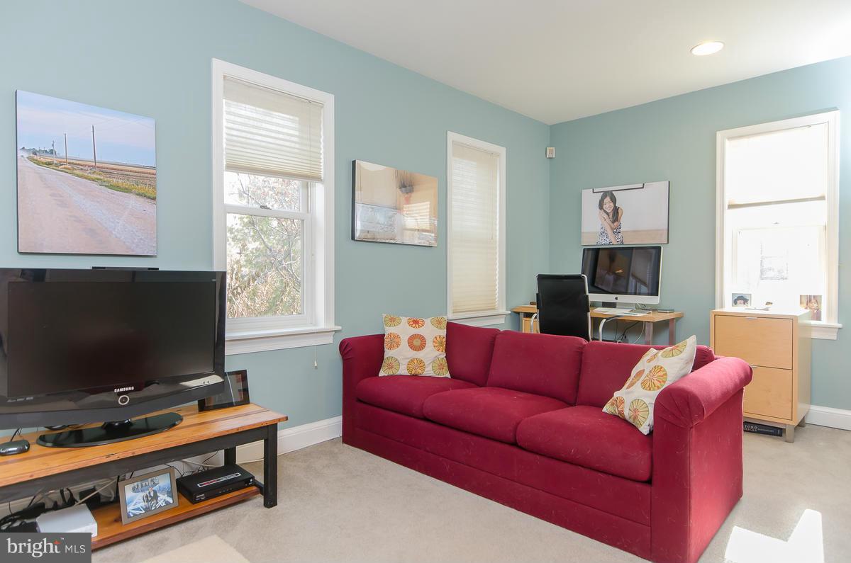 214 11th Street Northeast Washington, DC 20002 - Photo 25 of 30 a living room with furniture and a flat screen tv