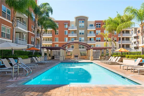 a view of a swimming pool with outdoor seating