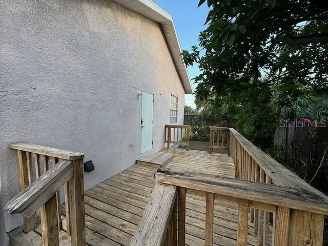 a view of backyard with deck and trees