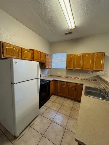 a kitchen with a refrigerator sink and stove