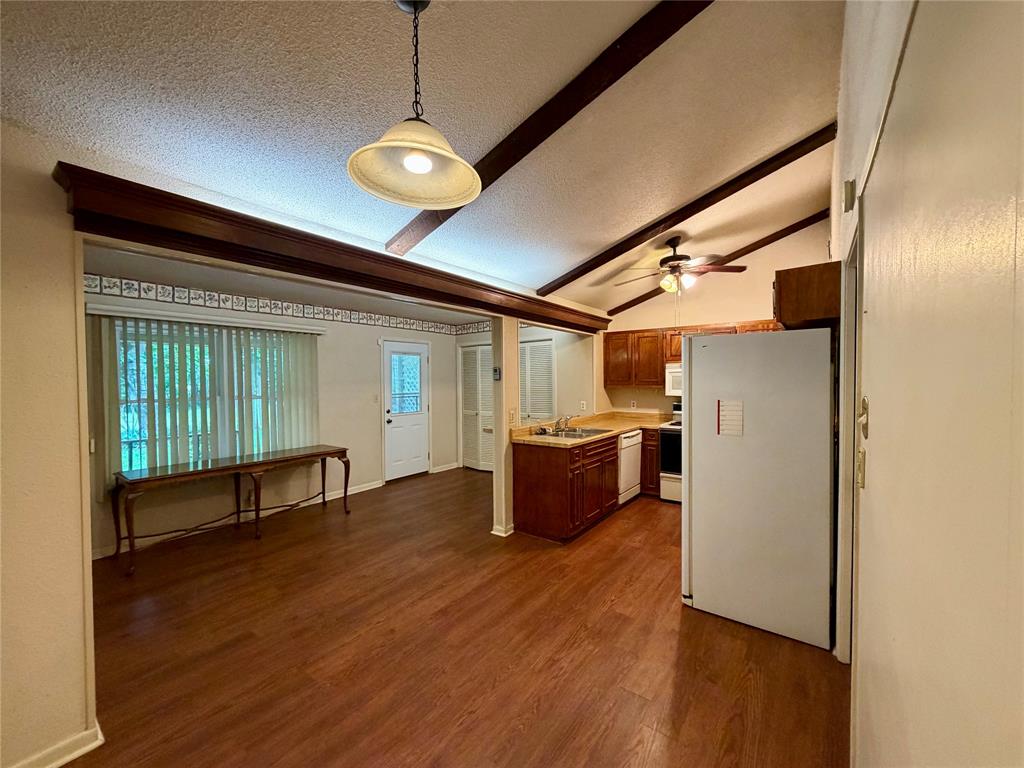 2030 Sycamore Street Paris, TX 75460 - Photo 6 of 24 Vaulted ceiling with wood beams and ceiling fan