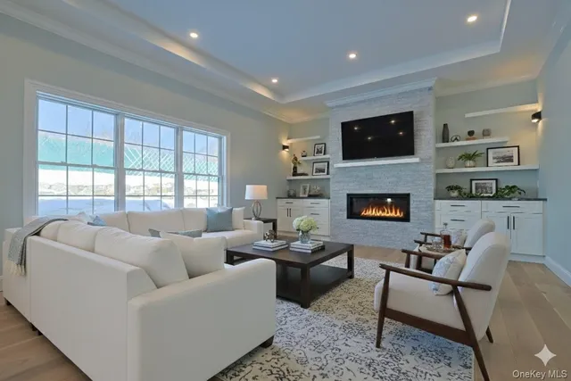 a living room with furniture a flat screen tv and a fireplace