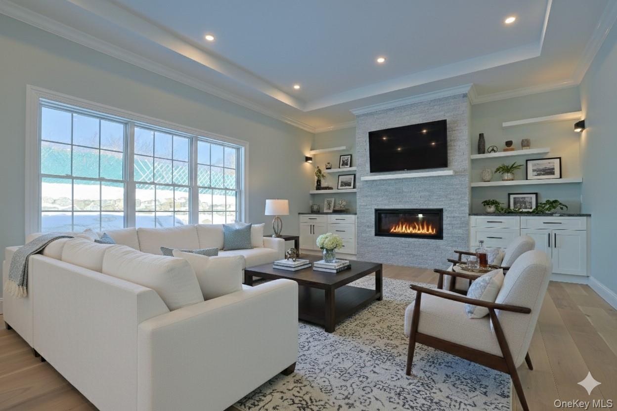 41 Croton Dam Road Ossining, NY 10562 - Photo 11 of 30 a living room with furniture a flat screen tv and a fireplace
